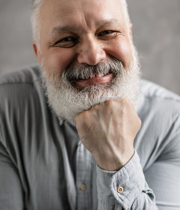 Portrait of a smiling, confident person with a clear and calm expression.